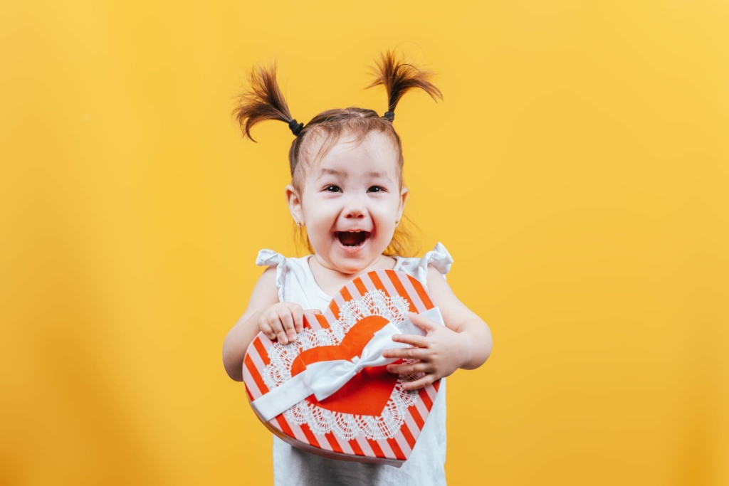 Daycare child smiling with a gift box